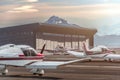 Private propeller planes parked at the airport. Private airplanes at sunset.