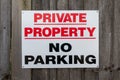 Private Property No Parking Sign on a wooden fence Royalty Free Stock Photo