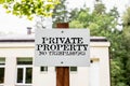 Private property no trespassing. White sign next to the property Royalty Free Stock Photo