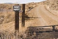 Private property fence sign cattle guard dirt road Royalty Free Stock Photo