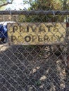 Private property yellow sign on  chain link fence Royalty Free Stock Photo