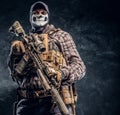 Private security service contractor wearing a balaclava skull and cap holding an assault. Royalty Free Stock Photo