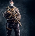 Private security service contractor wearing a balaclava skull holding an assault. Royalty Free Stock Photo