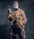 Private security service contractor wearing a balaclava skull holding an assault. Royalty Free Stock Photo