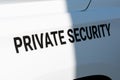 Private Security text sign on the side of white patrol vehicle used by a private security service company. Close up Royalty Free Stock Photo