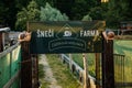 Private snail farm, Sneci Farma, entrance gate, wooden sign, snail restaurant, sunny day at sunset, Garden snail sculpture, Prague