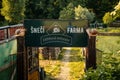 Private snail farm, Sneci Farma, entrance gate, wooden sign, snail restaurant, sunny day at sunset, Garden snail sculpture, Prague