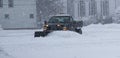 Private snow plow clearing parking lot for businesses Royalty Free Stock Photo