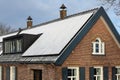 Private solar panels with snow on the roof of old historic and monumental house in the winter. Royalty Free Stock Photo