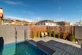 Private terrace on the roof of a house with swimming pool, sunbeds and wooden fence on sunny day in Barcelona. Royalty Free Stock Photo