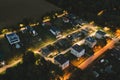 Private territory with houses and street lit at night, view of private houses from above