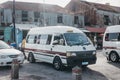 Private white mini buses parked at the outdoor bus terminal in Bridgetown, Barbados.