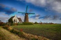 Farm and windmill in the country side in Holland. Royalty Free Stock Photo