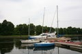 Private yachts, motorboats and boats moored at the old wooden pier. Royalty Free Stock Photo