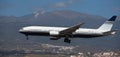 Privilege Style Airlines flies in the blue sky. Landing at Tenerife Airport. El Teide volcano in the background