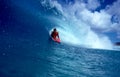 Pro Bodyboarder Alex Kinimaka in a Blue Tube Wave Royalty Free Stock Photo