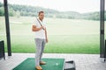 Pro golf player aiming shot with club on course. Male golfer on putting green about to take the shot Royalty Free Stock Photo