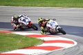 Pro Motorcycle racing, riders leaning into curve Royalty Free Stock Photo