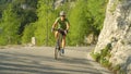 Pro road cyclist training for a race through the sunny mountains in Slovenia. Royalty Free Stock Photo