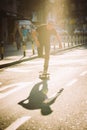 Pro skateboard rider in front of car on city street