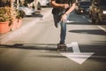 Pro skateboard rider in front of car on city street