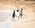 Pro Surfers Walking at Sunset Beach Hawaii Royalty Free Stock Photo