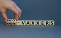 Pro-vaxxers or anti-vaxxers symbol. Doctor turns cubes, changes words `anti-vaxxers` to `pro-vaxxers`. Beautiful grey backgrou Royalty Free Stock Photo