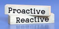 Proactive, reactive - words on wooden blocks