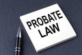 PROBATE LAW text on the sticker with pen on the black background
