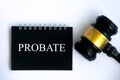 Probate text on black notepad and gavel on white cover background.
