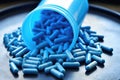 probiotic capsules spilling from a blue container