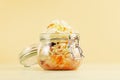 Sauerkraut in glass jar on a light background