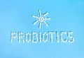 Probiotics word and sun made of pills on blue background