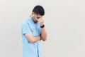 Problem, depression or sickness. Portrait of sad alone handsome young bearded man in blue shirt standing, holding head down and Royalty Free Stock Photo