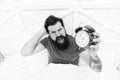 Problem early morning awakening. Why you suffering in mornings. Get up with alarm clock. Waking up early. Man bearded Royalty Free Stock Photo