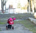 Problem of hopeless barrenness and bringing babies to baby boxes hatch. Lonely pink carriage outdoors without parents