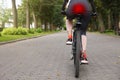 Problem of injured coccyx. Woman riding bicycle on road