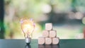 Problem solving and creative ideas to lead the business in the right direction, light bulbs and wooden blocks on table nature Royalty Free Stock Photo