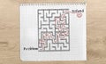 Problem Solving maze, Problem Solved text, maze solution hand drawn on with red marker on graph paper over wooden desk from Royalty Free Stock Photo