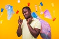 Problem of trash, plastic recycling, pollution and environmental concept - african american man carrying garbage for Royalty Free Stock Photo
