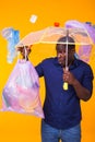 Problem of trash, plastic recycling, pollution and environmental concept - surprised african american man carrying Royalty Free Stock Photo