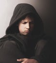 Problems of teenagers. Portrait of a sad teen boy in a dark key