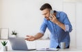 Problems At Work. Angry Businessman Talking On Cellphone, Having Troubles With Computer Royalty Free Stock Photo