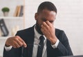 Portrait of tired african american businessman taking his glasses off Royalty Free Stock Photo