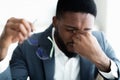 Tired african businessman taking his glasses off Royalty Free Stock Photo