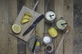 Proccess of making detox water with lemon in a glass jar with a handle, lid, and straw Royalty Free Stock Photo