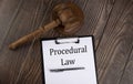 PROCEDURAL LAW text on the paper with gavel on wooden background