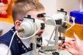 The procedure for the examination and hardware treatment  eyes of a child. The child sits in front of ophthalmological treatment m Royalty Free Stock Photo