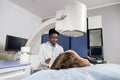 Procedure of extracorporeal shock wave lithotripsy in modern urology medical center. Young African man doctor providing