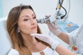 Procedure for laser removal of neoplasms on the face in a cosmetology clinic Royalty Free Stock Photo